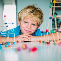 Child building geometric shapes